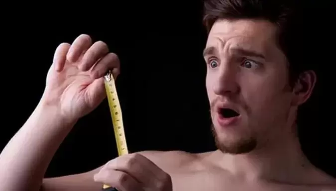 Man measuring his penis before enlargement